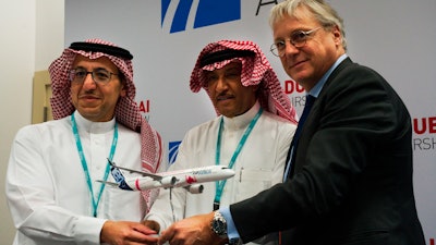 Flynas CEO Bander al-Mohanna, left, flynas chairman Ayed Thawab al-Jeaid, center, and Airbus' chief commercial officer Christian Scherer pose during a news conference at the Dubai Airshow in Dubai, United Arab Emirates on Tuesday, Nov. 19.