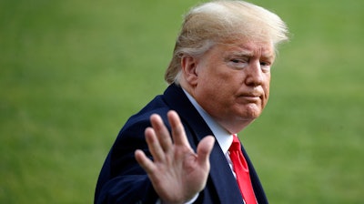 President Donald Trump waves as he walks to the Marine One helicopter after speaking to the media on Wednesday, Nov. 20, as he leaves the White House in Washington, en route to Texas.