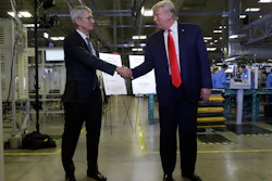 Apple CEO Tim Cook and President Donald Trump shake hands during a tour of an Apple manufacturing plant on Wednesday, Nov. 20 in Austin.
