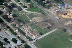 This April 18, 2013 aerial file photo shows the remains of a nursing home, left, apartment complex, center and fertilizer plant, right, destroyed by an explosion at a fertilizer plant in West, Texas. The Trump administration is scaling back chemical plant safety measures that were put in place after the Texas fertilizer plant explosion in 2013 that killed 15 people.