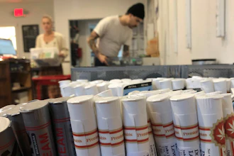 In this Sept. 20, 2019 file photo, employees at the marijuana retailer Bridge City Collective in Portland, OR, can be seen setting up the store for the day behind a row of marijuana products for sale there.