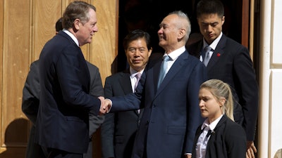 In this Oct. 11, 2019, file photo, Chinese Vice Premier Liu He, center right, shakes hands with U.S. Trade Representative Robert Lighthizer, center left, after a minister-level trade meeting at the Office of the United States Trade Representative in Washington.