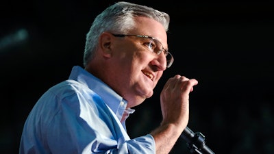 In this July 13, 2019 file photo, Indiana Governor Eric Holcomb speaks at a campaign rally in Knightstown, IN. Holcomb is facing calls from Democrats to explain his role in Amazon being cleared in a worker's death despite initial findings of major safety violations.