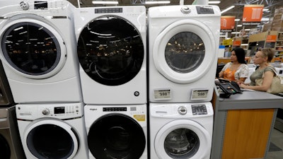 In this Sept. 23, 2019 file photo, clothes dryers are stacked on top of washing machines at a Home Depot store location, in Boston.