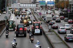 Farmer drive their tractors on the Paris ring road in Paris on Wednesday, Nov. 27. French farmers are driving tractors into Paris and Lyon to protest stagnant revenues and unfair competition. The placard reads « Save your farmer ».