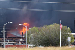 Smoke and fire are visible from the TPC Group Port Neches Operations explosion on Wednesday, Nov. 27, 2019, in Port Neches, Texas. Three workers were injured early Wednesday in a massive explosion at the Texas chemical plant that also blew out the windows and doors of nearby homes.