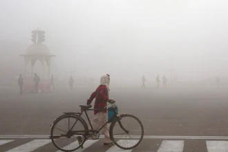 This Jan. 18, 2019 file photo shows a cyclist amidst morning smog in New Delhi, India. Beth Gardiner's new book 'Choked' documents how air pollution is responsible for seven million premature deaths around the world. Inger Andersen, head of the U.N. Environment Program, says the world needs 'quick wins to reduce emissions as much as possible in 2020.' Ahead of a global climate summit in Madrid next week, her agency published a report Tuesday showing the amount of planet-heating gases released into the atmosphere hitting a new high last year.