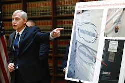 U.S. Attorney Richard P. Donoghue announces charges against Aventura Technologies, Thursday, Nov. 7, 2019, in the Brooklyn borough of New York. The New York company has been charged with illegally importing and selling Chinese-made surveillance and security equipment to U.S. government agencies and private customers.