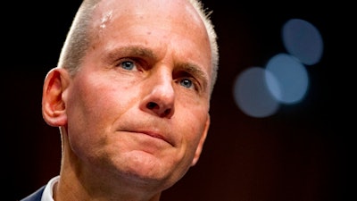 In this Oct. 29, 2019, file photo Boeing Company President and Chief Executive Officer Dennis Muilenburg appears before a Senate Committee on Commerce, Science, and Transportation hearing on 'Aviation Safety and the Future of Boeing's 737 MAX' on Capitol Hill in Washington. Boeing’s new chairman gave Muilenburg a vote of confidence Tuesday , Nov. 5, and said the chief executive is giving up any bonus this year.