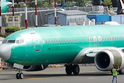 In this May 8, 2019, file photo workers stand near a Boeing 737 MAX 8 jetliner being built for American Airlines prior to a test flight in Renton, Wash. American Airlines CEO Doug Parker says his airline is feeling more confident that its grounded Boeing 737 Max jets will soon be approved to fly again.