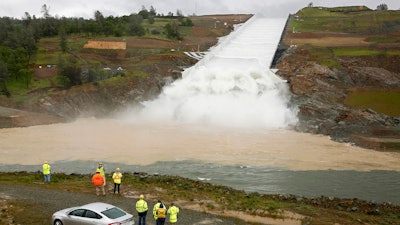 In this April 2, 2019, file photo, water flows down the Oroville Dam spillway in Oroville, California.