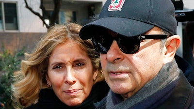 This March, 2019, file photo shows former Nissan Chairman Carlos Ghosn, right, and his wife Carole in Tokyo. Ghosn, awaiting trial in Japan on financial misconduct charges, has received permission from a Tokyo court to talk for one hour in a video call with his wife.