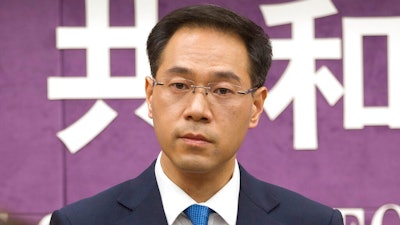 In this March 29, 2018, file photo, Chinese Ministry of Commerce spokesman Gao Feng listens to a reporter's question during a press conference at the Ministry of Commerce in Beijing. On Thursday, Nov. 7, 2019, China's Commerce Ministry says Washington and Beijing have agreed to cancel tariff hikes as their trade negotiations progress.