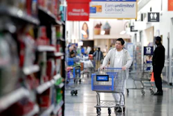 In this Nov. 9, 2017, file photo, a man pushes a cart while shopping at a Walmart store in North Bergen, NJ.
