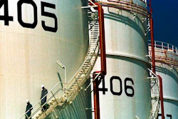 In this Monday, September 25, 2000 file photo, two workers climb down from one of the tanks in an oil tank-farm in Jebel Ali, 25 miles (40 kms.) south of Dubai in the United Arab Emirates. The United Arab Emirates now says it is home to the world's sixth-largest crude oil reserves, surpassing fellow Gulf Arab nation Kuwait.