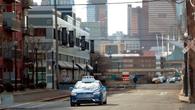 In this Dec. 18, 2018 file photo, one of the test vehicles from Argo AI, Ford's autonomous vehicle unit, navigates through the strip district near the company offices in Pittsburgh. The nation’s road-safety regulator is under fire again for what critics call lax oversight of tests involving autonomous vehicles. The nation’s top transportation safety investigator said Tuesday, Nov. 19, 2019, that the National Highway Traffic Safety Administration doesn’t give enough direction to companies developing more automated cars.