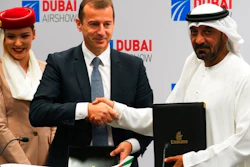 Airbus CEO Guillaume Faury, center, shakes hands with Sheikh Ahmed bin Saeed Al Maktoum, the chairman and CEO of the Dubai-based long-haul carrier Emirates, at the Dubai Airshow in Dubai, United Arab Emirates, Monday, Nov. 18, 2019. The Dubai-based airline Emirates announced Monday a new order for 20 additional wide-body Airbus A350-900 planes in a deal worth $6.4 billion. This brings the airline's total order for the aircraft to 50 Airbus A350s costing $16 billion at list price.