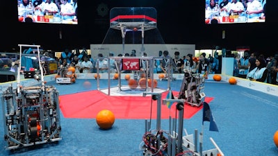 In this Friday, Oct. 25, 2019 photo, a team from Korea, on the right, competes with UAE Falcons during the First Global Challenge, a robotics and artificial intelligence competition in Dubai, United Arab Emirates. Seeking to bolster its image as a forward-looking metropolis, Dubai hosted the largest-ever international robotics contest this week, challenging young people from 190 countries to find solutions to global ocean pollution.