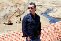 In this July 24, 2019, file photo, Gov. Gavin Newsom tours the Chevron oil field west of Bakersfield where a spill of more than 800,000 gallons flowed into a dry creek bed in McKittrick, Calif. Newsom's administration has temporarily banned new oil wells in California if they use an extraction method that is linked to an ongoing oil spill in Kern County. On Tuesday, Nov. 19, 2019, the Division of Oil, Gas and Geothermal Resources announced it will not approve new oil wells that use high-pressure steam to soften the thick crude underground so it can flow more easily.