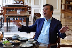In this Aug. 20, 2019, photo, Huawei's founder Ren Zhengfei gestures as he chats with Huawei executives at the company campus in Shenzhen in Southern China's Guangdong province. Ren says its troubles with President Donald Trump are hardly the biggest crisis he has faced while working his way from rural poverty to the helm of China’s first global tech brand.