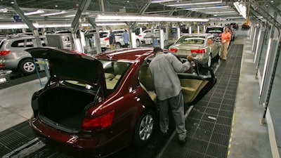 In this Feb 1, 2008, file photo, Hyundai Motor Company employees put the finishing touches on vehicles in Montgomery, Ala. Hyundai will build a pickup-style sport-utility vehicle at its plant in Alabama, which the company said Wednesday, Nov. 13, 2019, is being enlarged in a $410 million expansion project.