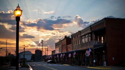 In this Aug. 23, 2015 file photo, the sun rises behind Main Street in Plains, Ga. The market for small businesses cooled further during the third quarter as fallout from trade wars made companies look less appealing to buyers.