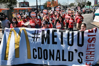In this Sept. 18, 2018, file photo, McDonald's workers carry a banner and march towards a McDonalds in south Los Angeles. Roughly a third of American workers say they've changed how they act at work in the past year, as the #MeToo movement has focused the nation's attention on sexual misconduct. That's according to a new poll of full- or part-time workers released Tuesday by The Associated Press-NORC Center for Public Affairs Research and the software company SAP.
