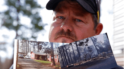 In this Thursday Oct. 24, 2019, photo, Bill Husa displays before-and-after photos of his home lost in last year's Camp Fire in Paradise, Calif. Husa's home is one of nearly 9,000 Paradise homes destroyed in the deadliest and most destructive wildfire in California history.