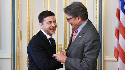 In this May 20, 2019, file photo, Ukrainian President Volodymyr Zelenskiy, left, and Energy Secretary Rick Perry share a joke during their meeting in Kiev, Ukraine.