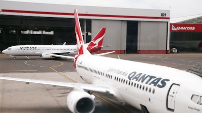 In this Feb. 26, 2015, file photo, a Qantas 737 plane maneuvers behind another 737 parked at a gate at Sydney Airport in Sydney. Qantas on Wednesday, Oct. 31, 2019, said it had found cracking in one 737, following calls from the US Federal Aviation Administration for all airlines to check their fleets of the aircraft.