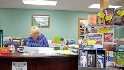 Darlene Miser works behind the counter of MM Feed Supply, in Pleasant City, Ohio, on Oct. 30, 2019. The feed supply store added broadband about five years ago to meet business demands. While the addition helped in some ways, speeds have slowed. After spending $30,000 to date for internet, Miser said they are unsure what the future holds when their contract ends.