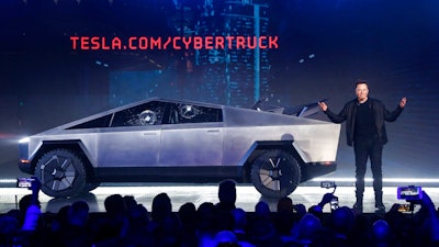 In this Thursday, Nov. 21, 2019, file photo, Tesla CEO Elon Musk introduces the Cybertruck at Tesla's design studio in Hawthorne, Calif. Tesla has received nearly 150,000 orders for its new electric pickup truck since the automaker revealed the futuristic vehicle earlier this week to mixed reviews, Musk tweeted Saturday, Nov. 23.