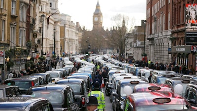In this Wednesday, Feb. 10, 2016 file photo, London taxis block the roads during a protest in central London, concerned with unfair competition from services such as Uber. London’s transit operator says it is not renewing Uber’s license to operate in the British capital. Uber’s license expires Monday Nov. 25, 2019.
