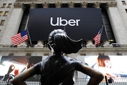 In this May 10, 2019, file photo the statue of Fearless Girl stands in front of the New York Stock Exchange before Uber holds its initial public offering. Uber reports financial results Monday, Nov. 4.