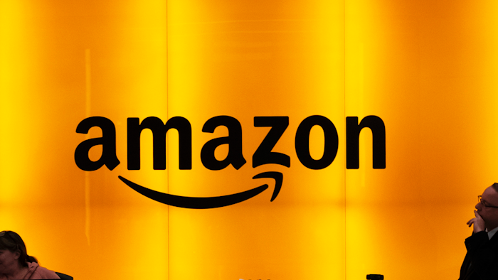 In this Feb. 14, 2019, file photo, people stand in the lobby of Amazon's offices in New York.