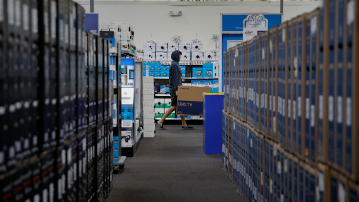 In this Nov. 26, 2019, file photo a man carries a television while shopping ahead of Black Friday at a Best Buy in Henderson, Nev. On Monday, Dec. 23, the Commerce Department releases its November report on durable goods.