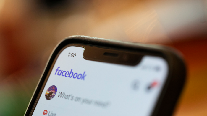 In this Aug. 11, 2019, file photo an iPhone displays a Facebook page in New Orleans. A Ukrainian security researcher says a database with the names, phone numbers and unique user IDs of more than 267 million Facebook users was exposed on the open internet for at least 10 days this month.