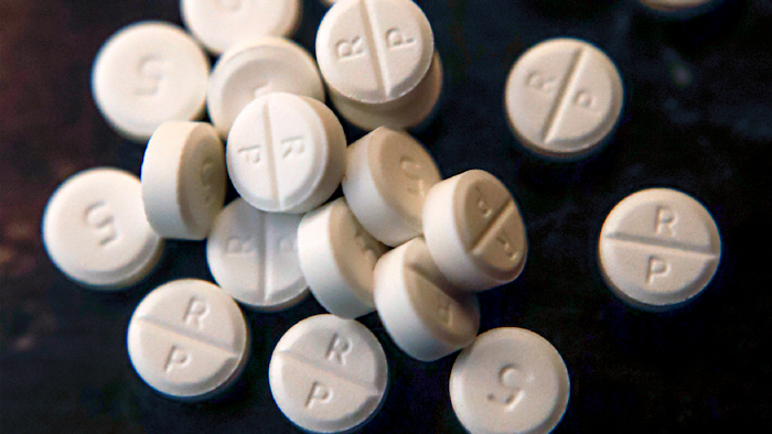 This June 17, 2019, file photo shows 5-mg pills of Oxycodone. The judge overseeing the bankruptcy case of OxyContin maker Purdue Pharma will consider Wednesday, Dec. 4, 2019 whether the company's CEO should get a bonus equal to half his $2.6 million salary.