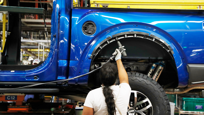 In this Sept. 27, 2018, file photo a United Auto Workers assemblyman works on a 2018 Ford F-150 truck being assembled at the Ford Rouge assembly plant, in Dearborn, Mich. Ford Motor Co. said Tuesday, Dec. 17, 2019, that it is adding 3,000 jobs at two factories in the Detroit area and investing $1.45 billion to build new pickup trucks, SUVs, and electric and autonomous vehicles. At the Dearborn truck plant $700 million will be invested.
