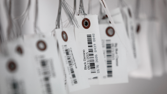 In this Sept. 24, 2015, file photo, tags with bar codes hang at a facility in Flandreau, S.D. George J. Laurer, whose invention of the Universal Product Code at IBM transformed retail and other industries around the world, died Thursday, Dec. 5, 2019, at his home in Wendell, N.C. He was 94.