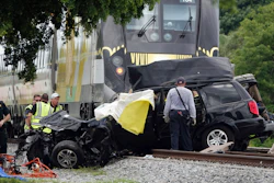 In this Aug 25, 2019 file photo, Broward Sheriff's Deputies and Pompano Beach Fire Rescue work the scene of a fatal accident on North Dixie Highway in Pompano Beach, Fla. The Florida higher-speed passenger train service tied to Richard Branson’s Virgin Group has the worst per-mile death rate in the U.S. The first death involving a Brightline train happened in July 2017 during test runs. An Associated Press analysis of Federal Railroad Administration data shows that since then, 40 more have been killed. That amounts to a rate of more than one a month and about one for every 29,000 miles (47,000 kilometers) the trains have traveled since the first death.