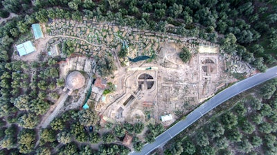 In this undated photo provided by the Greek Culture Ministry on Tuesday, Dec. 17, 2019, an aerial view is seen of two 3,500-year-old tombs, center and right, discovered near the southwestern Greek town of Pylos, together with one found decades ago, left. The ministry said American archaeologists have discovered two monumental royal tombs dating 3,500 years back, near a large Bronze Age palace that featured in Homer's Odyssey. Recovered grave goods included a golden seal ring and a golden Egyptian amulet.