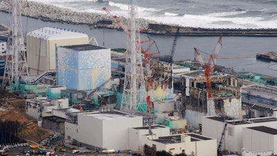 This March 11, 2012, file photo, shows three melted reactors, from left, Unit 1, Unit 2 and Unit 3 at Fukushima Dai-ichi nuclear power plant in Okuma, Fukushima prefecture, Japan. Japan revised a roadmap on Friday, Dec. 27, 2019, for the tsunami-wrecked Fukushima nuclear plant cleanup, further delaying the removal of thousands of spent fuel units that remain in cooling pools since the 2011 disaster.