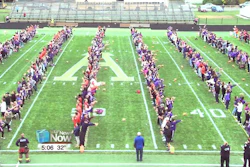 This still image taken from video provided by WLIO-TV shows 950 people throwing footballs at the same time on Oct. 25, 2019 at the Ada War Memorial Stadium football field in Ada, Ohio. The Ohio town long associated with the manufacturing of footballs has set a Guinness World Record for the most footballs thrown at once. The record-keeping organization certified the record.