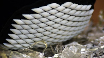 A demonstration of the 3D printed flexible armor on broken glass.