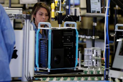 In this Nov. 20, 2019, file photo workers with Apple products being assembled before President Donald Trump tours an Apple manufacturing plant in Austin, Texas. On Monday, Dec. 2, the Institute for Supply Management, an association of purchasing managers, reports on activity by U.S. manufacturers in November.
