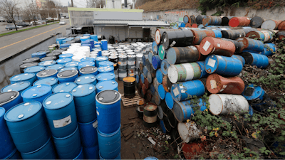 Dozens of barrels fill an outside storage area at Seattle Barrel and Cooperage Wednesday, Dec. 18, 2019, in Seattle. The century-old Seattle barrel company has been indicted along with its third-generation owner in what prosecutors describe as a long-running pollution conspiracy. The 36-count indictment, made public in U.S. District Court in Seattle on Wednesday, says the company used a hidden drain to pump caustic wastewater directly into the King County sewer system. That's despite telling officials that the company reused all its wastewater and didn't discharge any.