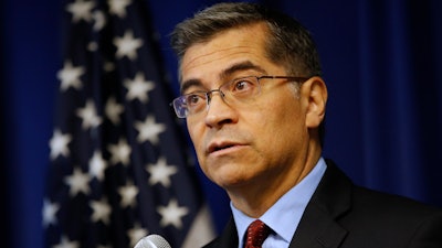 California Attorney General Xavier Becerra discusses settlements reached with 52 automobile parts manufacturers for illegal bid rigging during a news conference, Dec. 4, 2019, in Sacramento.