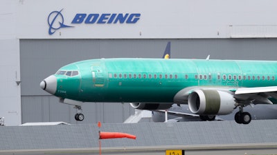 In this April 10, 2019, file photo a Boeing 737 MAX 8 airplane being built for India-based Jet Airways lands following a test flight at Boeing Field in Seattle. Boeing is reassuring airline industry leaders about the safety of the grounded 737 Max as it continues working to get the plane back in service. The aircraft maker invited about 30 union officials, safety experts and others to the Seattle area for two days of meetings with Boeing executives and factory tours.