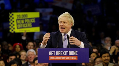 Britain's Prime Minister Boris Johnson speaks during his ruling Conservative Party's final election campaign rally at the Copper Box Arena in London, Wednesday, Dec. 11, 2019. Britain goes to the polls on Dec. 12.